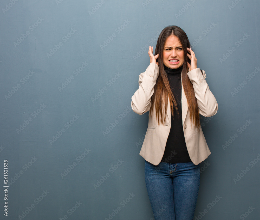 Young business woman covering ears with hands Young business woman covering ears with hands