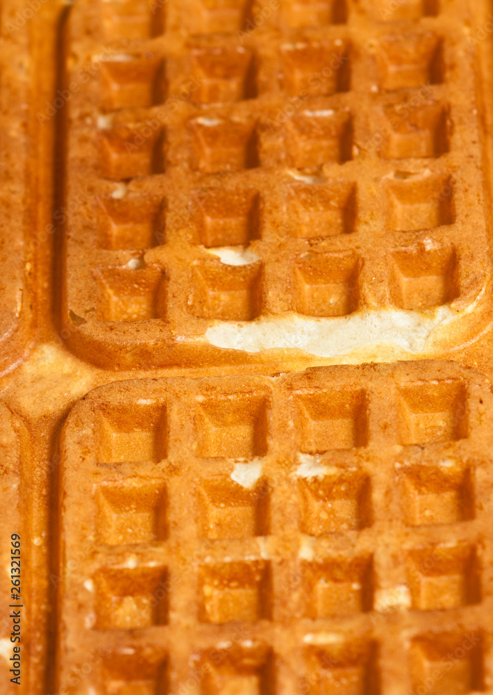 Top view, close up of two, freshly baked, homemade, waffles on an oval, white plate Top view, close up of two, freshly baked, homemade, waffles on an oval, white plate