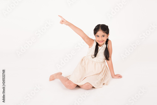 Female child sitting on the floor and indexing photo