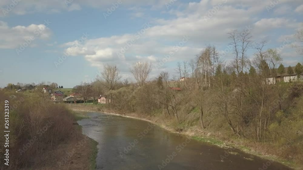 A shallow mountain river flows among stones and lush greenery over the plain. Clear water and beautiful nature for rest and relaxation in the reserve. Fishing in the ecosystem of temperate climate. A shallow mountain river flows among stones and lush greenery over the plain. Clear water and beautiful nature for rest and relaxation in the reserve. Fishing in the ecosystem of temperate climate.