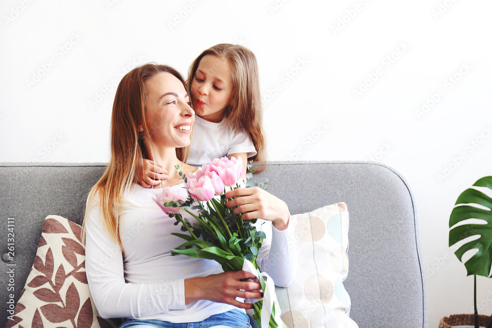Cute little five year old girl giving her mom a present for mothers day. Adorable scene with daughter surprizing her mum. Close up, background, portrait. Cute little five year old girl giving her mom a present for mothers day. Adorable scene with daughter surprizing her mum. Close up, background, portrait.