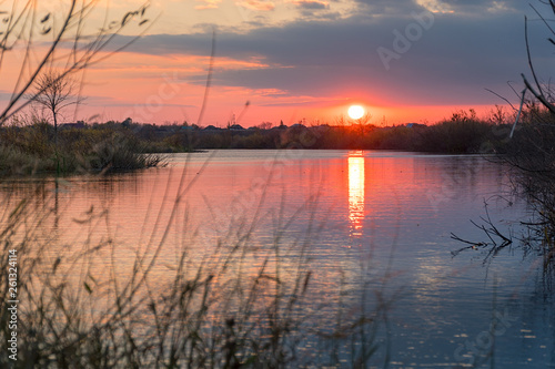 Fototapeta Naklejka Na Ścianę i Meble -  Sunset or sunrise on the cloudy sky on lake