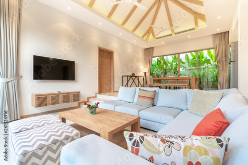 Luxury interior design in living room of pool villas. Airy and bright space with high raised ceiling © Stock PK