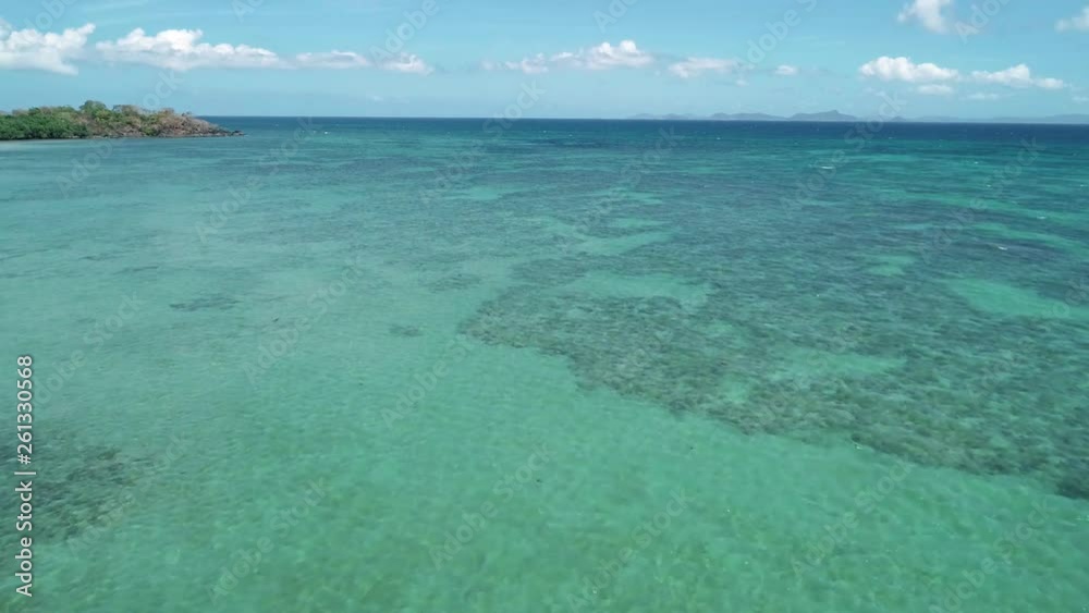 Flying over blue sea water surface, crystal clear water beautifully refracting the rays on the blue sea surface Flying over blue sea water surface, crystal clear water beautifully refracting the rays on the blue sea surface