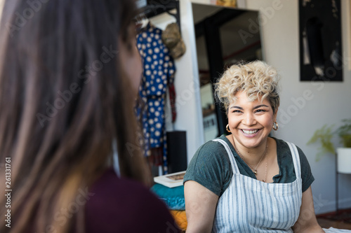 Woman talking with a friend and smiling at home