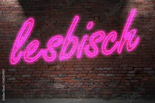 Neon lettering lesbisch (means lesbian in german) on Brick Wall at night