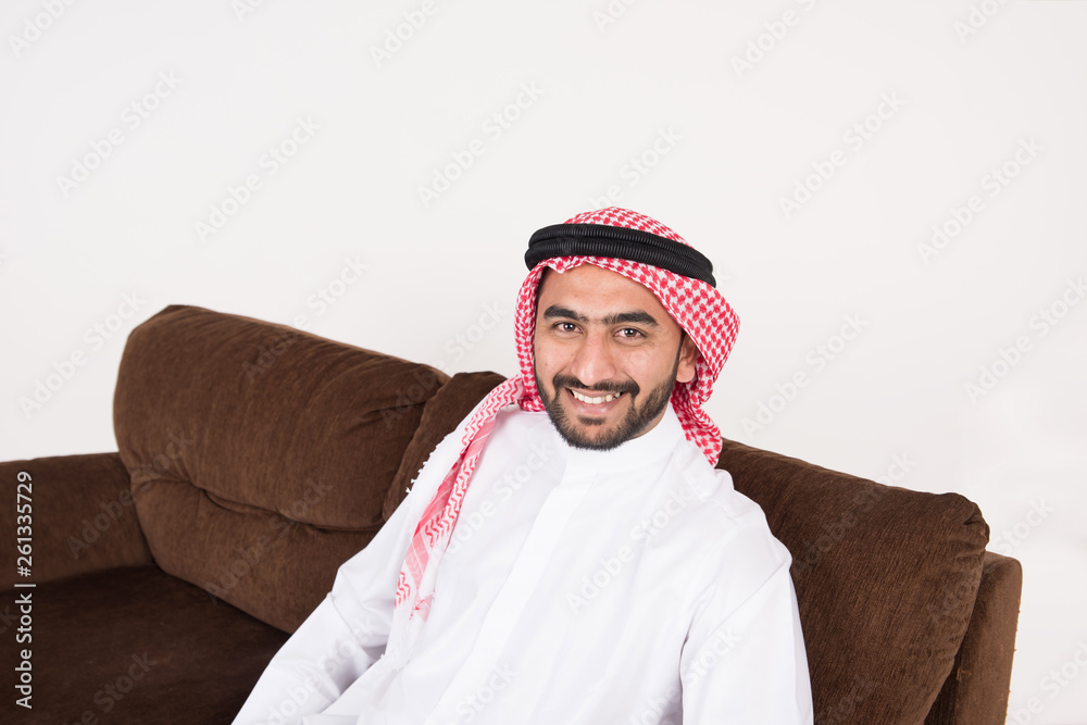 Arab man sitting on sofa chair at home