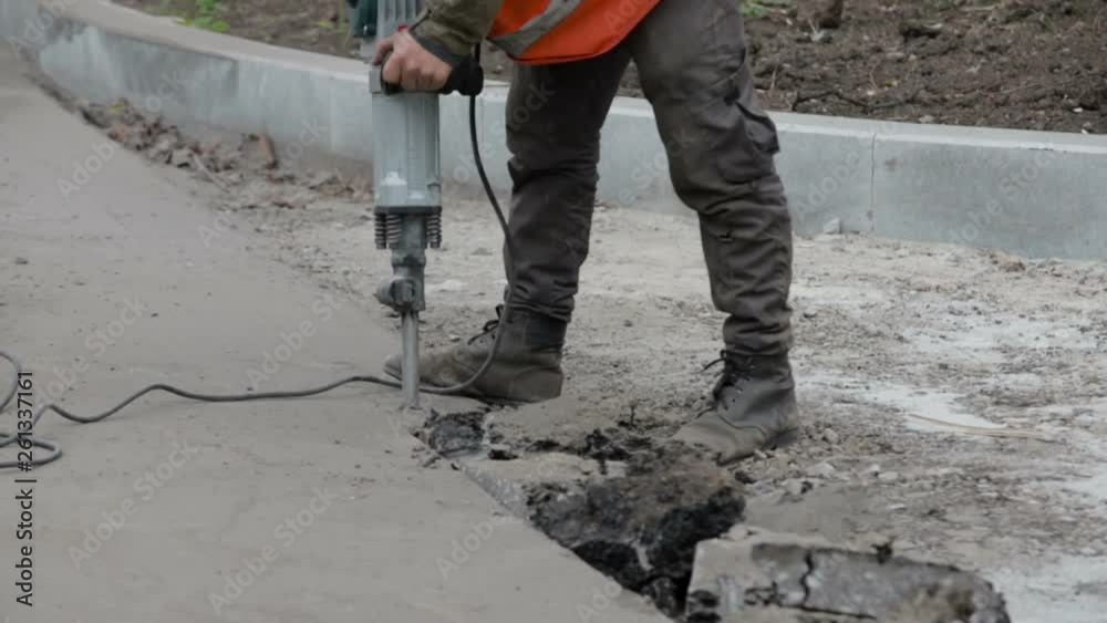 Demolition hammer hammering asphalt Demolition hammer hammering asphalt