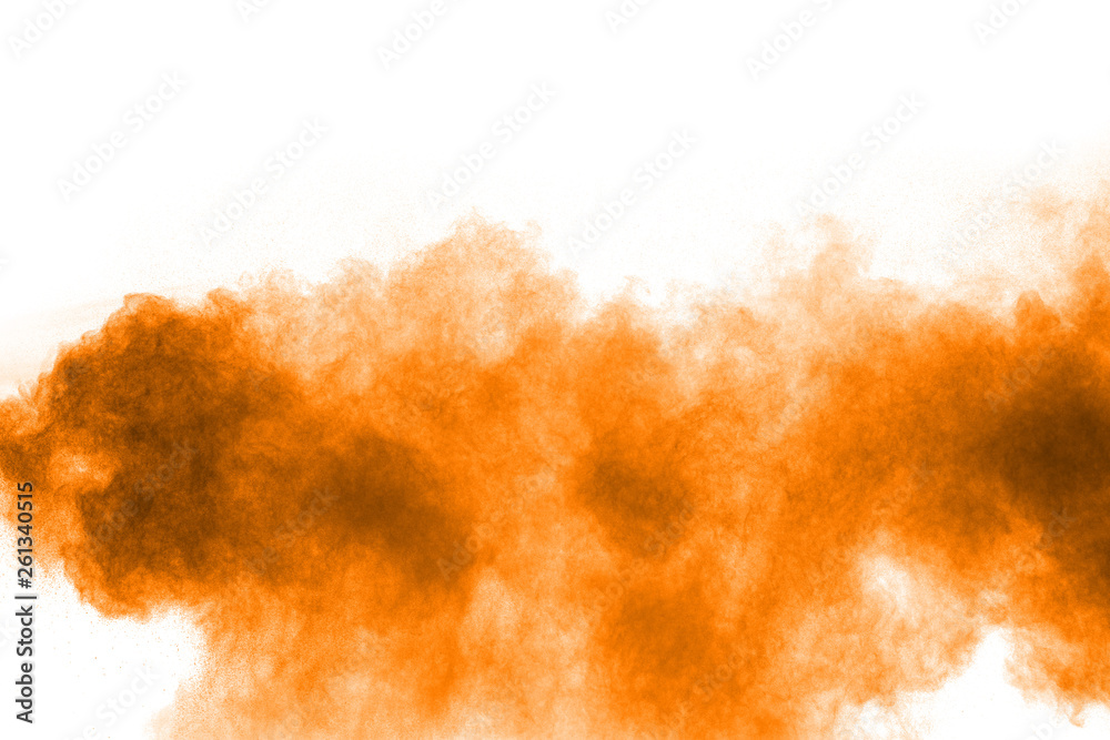 Orange color powder splatter on white background. Color particles splash.