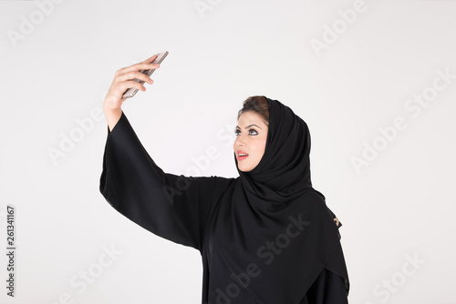 beautiful arab girl taking selfie with her smart phone