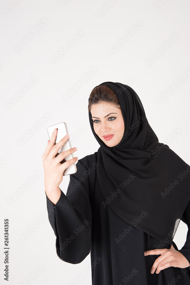 beautiful arab girl taking selfie with her smart phone beautiful arab girl taking selfie with her smart phone