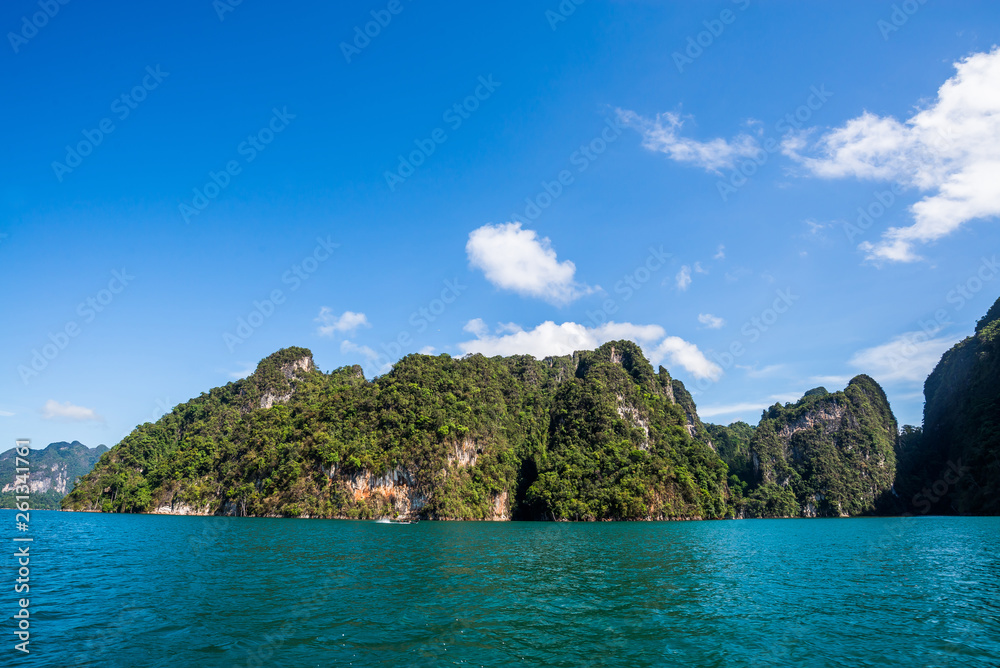 Beautiful nature rock mountains cliff and blue emerald water color lake river with blue clear sky in Ratchaprapa Dam at Khao Sok National Park, Surat Thani Province, Thailand. Asia tourism location. Beautiful nature rock mountains cliff and blue emerald water color lake river with blue clear sky in Ratchaprapa Dam at Khao Sok National Park, Surat Thani Province, Thailand. Asia tourism location.