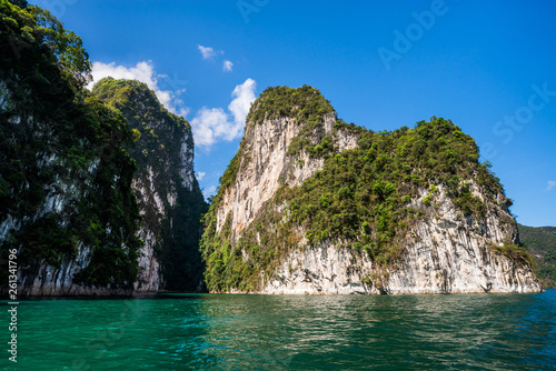 Beautiful nature rock mountains cliff and blue emerald water color lake river with blue clear sky in Ratchaprapa Dam at Khao Sok National Park  Surat Thani Province  Thailand. Asia tourism location.