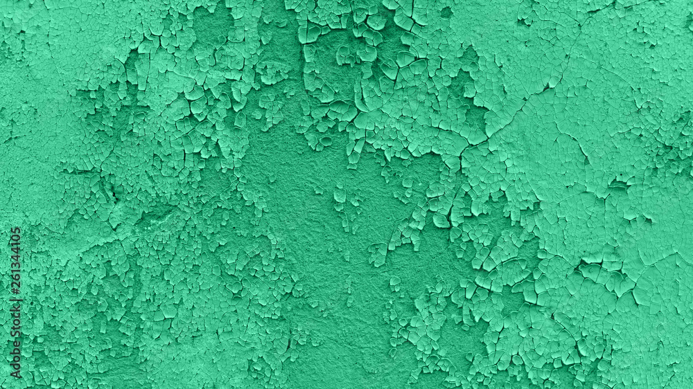 Closeup of peeling painted wall. Neo Mint color of the year 2020