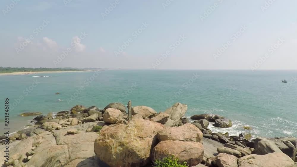 Aerial low Altitude shot above rocky rocks at sea beach seashore, Drone fly low Over Rocks to the open green water Coastline of Laccadive Sea Sri Lanka Aerial low Altitude shot above rocky rocks at sea beach seashore, Drone fly low Over Rocks to the open green water Coastline of Laccadive Sea Sri Lanka