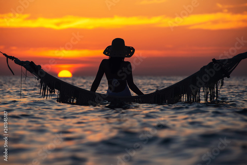 Canvas Print beautiful young woman silhouette with swing posing in the sea on sunset, maldivi
