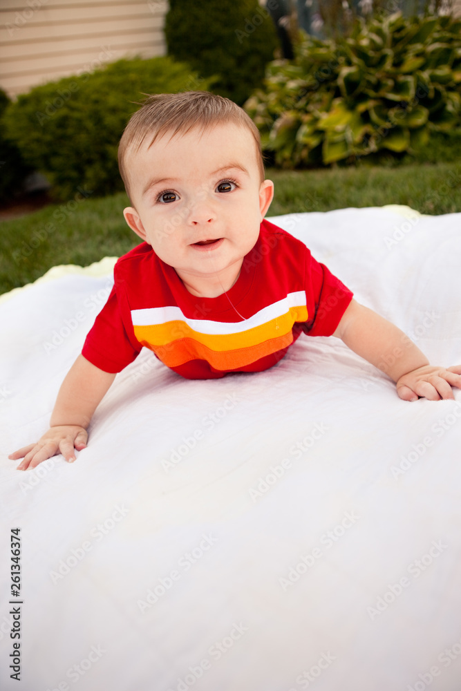 Happy Baby Boy Lying on Blanket Outside - Color Portrait