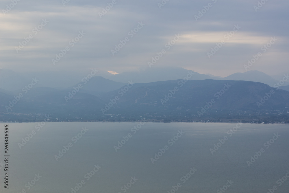 dramatic foggy weather mountain ridge silhouette along big lake waterfront dramatic foggy weather mountain ridge silhouette along big lake waterfront