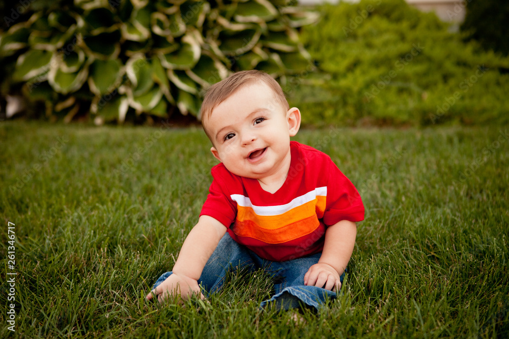 Happy Baby Boy Sitting in Grass Outside - Color Portrait Happy Baby Boy Sitting in Grass Outside - Color Portrait
