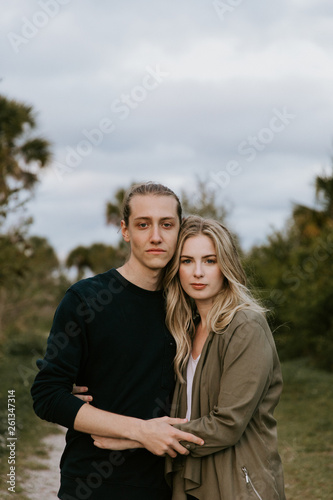 Romantic and Loving Young Adult Couple at the Park Looking At Nature and the Horizon for Portrait Pictures