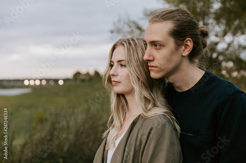 Romantic and Loving Young Adult Couple at the Park Looking At Nature and the Horizon for Portrait Pictures
