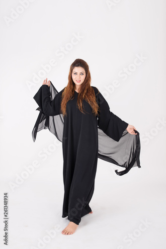 Beautiful Arab woman in traditional dress dancing