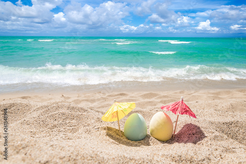 Happy easter lettering background with eggs on the sandy beach