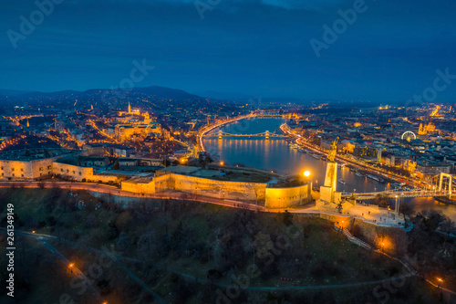Budapest, Hungary - Aerial panoramic view of Budapest at blue hour. This view includes illuminated Statue of Liberty on Gellert Hill, Buda Castle Royal Palace, Szechenyi Chain Bridge, Elisabeth Bridge