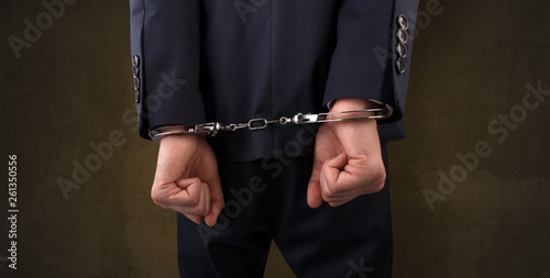 Close now arrested men hand with dark background and handcuffs 