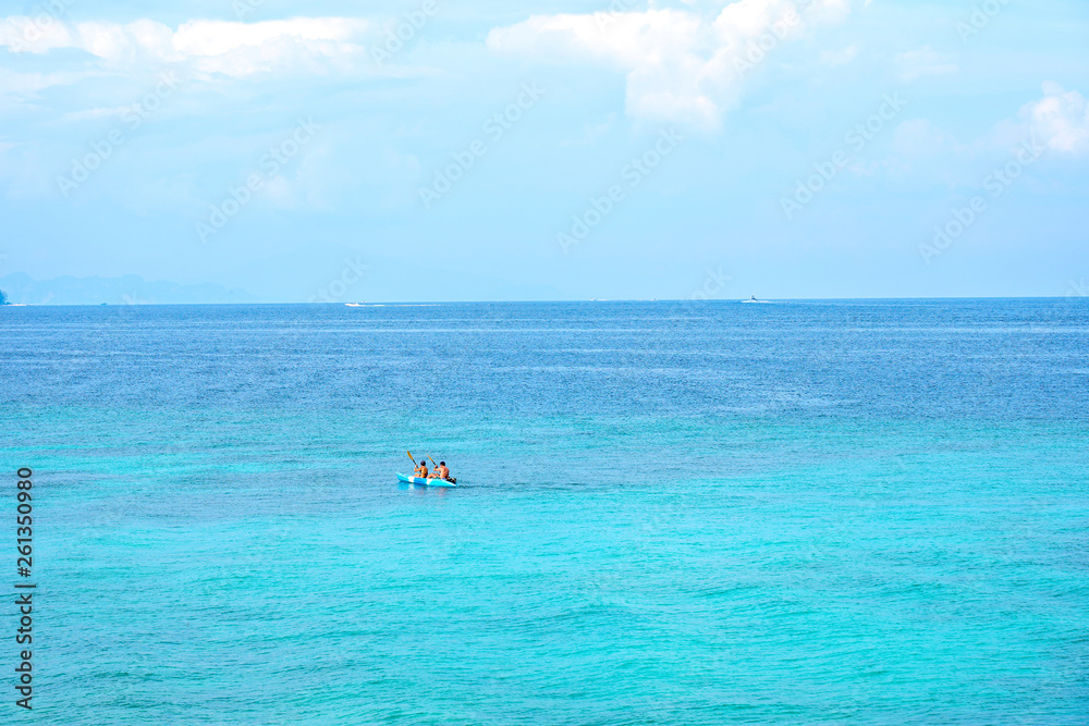 Traveller couple kayaking boat on summer tropical beach with blue sky background.Day off to ocean paradise.Happy Vacation holiday in beautiful outdoor scene landscape. Travel Journey Freedom concept. Traveller couple kayaking boat on summer tropical beach with blue sky background.Day off to ocean paradise.Happy Vacation holiday in beautiful outdoor scene landscape. Travel Journey Freedom concept.