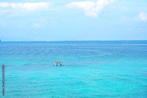 Traveller couple kayaking boat on summer tropical beach with blue sky background.Day off to ocean paradise.Happy Vacation holiday in beautiful outdoor scene landscape. Travel Journey Freedom concept.  © Poh Smith