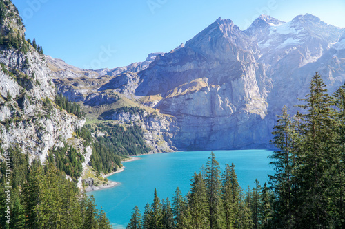 Scenic Panorama picture or postcard view of Oeschinensee lake Wooden chalet and Swiss Alps  Beautiful outdoor scene in Berner Oberland Kandersteg Switzerland.Vacation Holiday. 