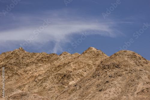 picturesque dramatic dry bare mountain ridge in desert wilderness Middle East region, panorama photography format on contrast blue sky background wallpaper daily planet concept with empty copy space