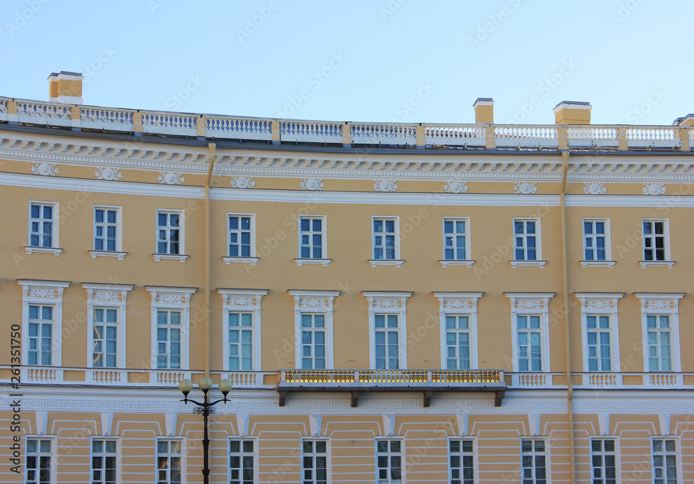 Old building facade classical architecture of minimalist house with yellow walls and windows pattern in row