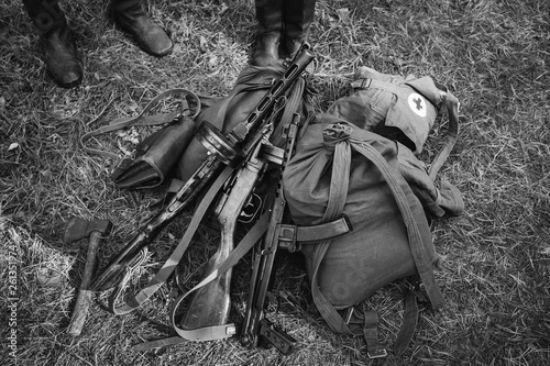 Soviet Russian Military Infantry Ammunition On Ground World War II Soviet Red Army Weapon. Submachine Guns PPS-43 And PPSh-41 On Ground. WWII WW2 Russian Ammunition. Photo In Black And White Colors photo