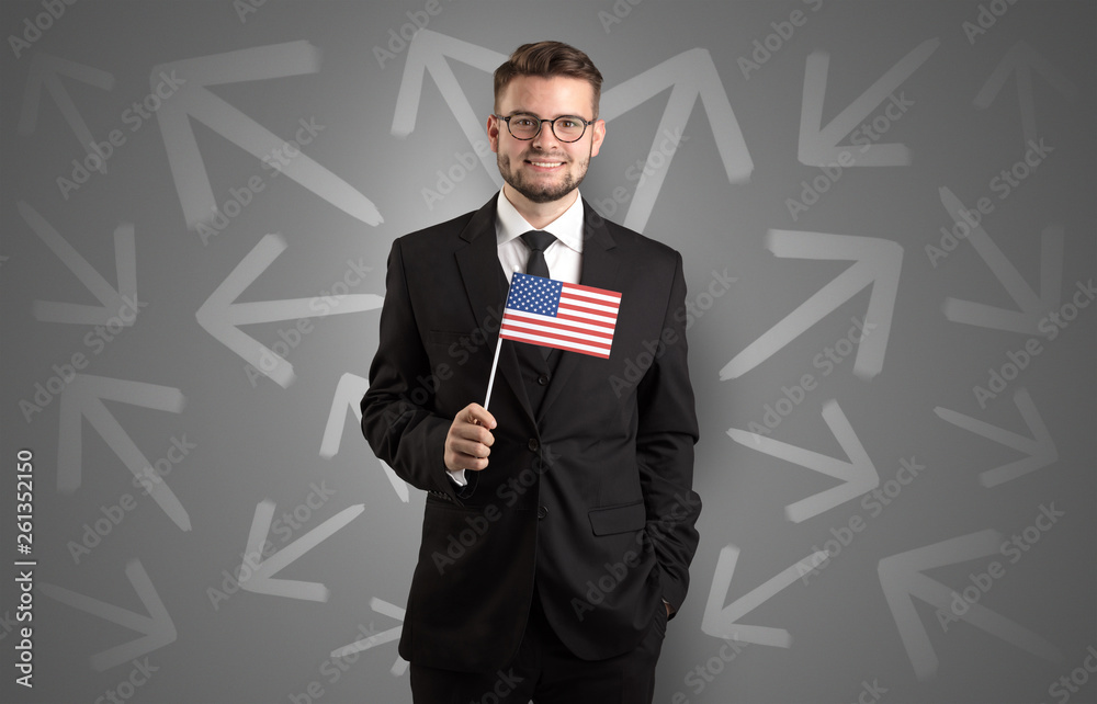 Cheerful elegant boy standing with flag on his hand and chalk drawn arrows around Cheerful elegant boy standing with flag on his hand and chalk drawn arrows around