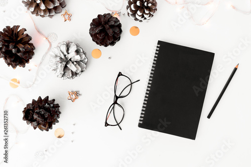 Notebook diary christmas mockup, pine cones and decorations on white background, flat lay top view.