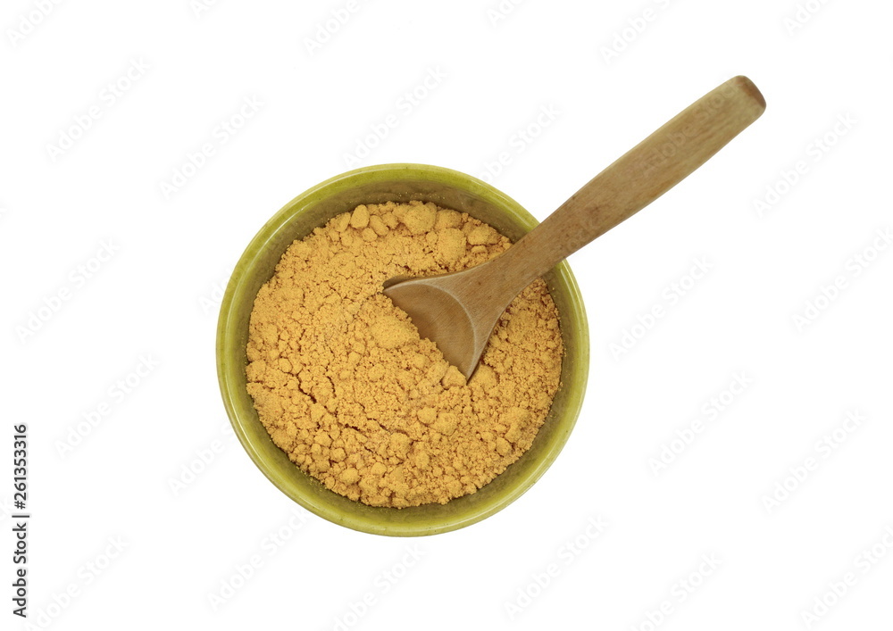 Turmeric, curcuma powder in a green bowl with wooden spoon isolated on white background. Heap of turmeric. Turmeric, curcuma powder in a green bowl with wooden spoon isolated on white background. Heap of turmeric.