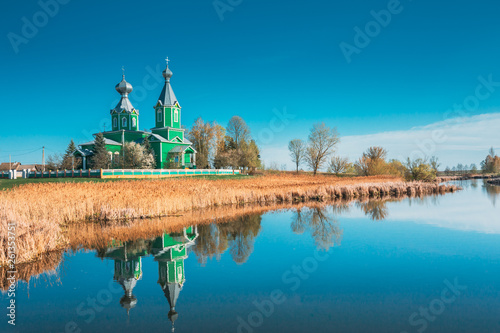 Old Wooden Russian Orthodox Church Near Lake In Early Spring Or Late Autumn Season. Sunny Day