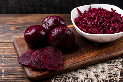 Boiled beet on dark wooden background.