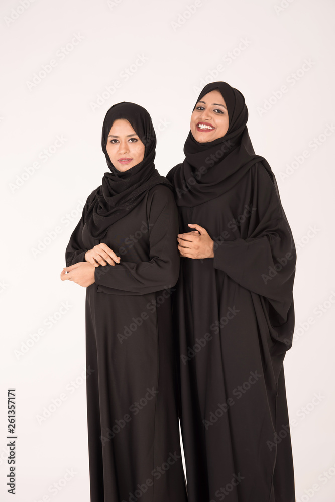 Arab women in traditional dress standing on white background Arab women in traditional dress standing on white background