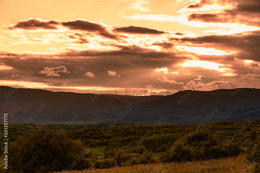 Wind Energy. Wind turbines at sunset sky. Beautiful landscape.