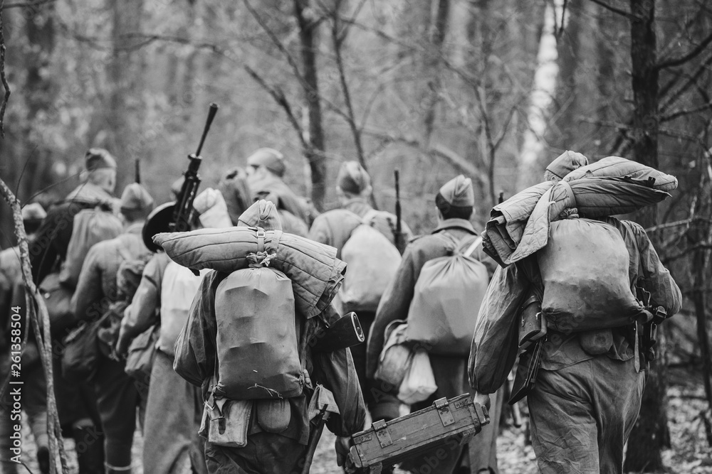 Foto de Re-enactors Dressed As World War II Russian Soviet Red Army  Soldiers Marching Through Forest In Autumn Day. Photo In Black And White  Colors. Soldier Of WWII WW2 Times do Stock