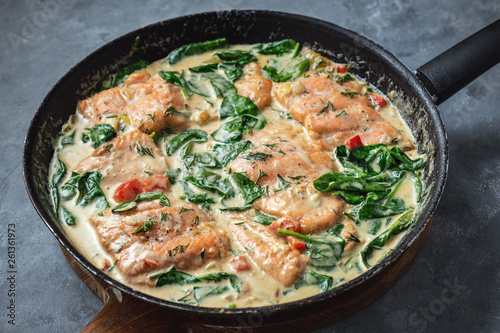 Salmon baked in cream sauce with spinach and bel pepper. 