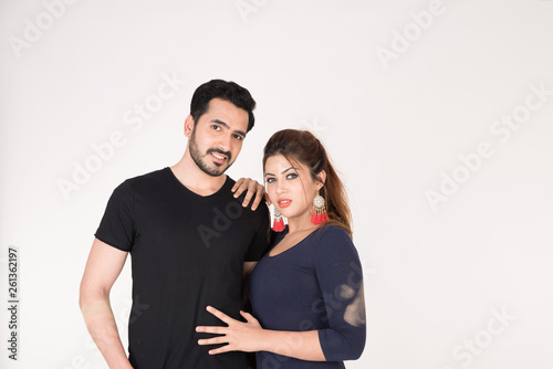 young couple together posing on white background