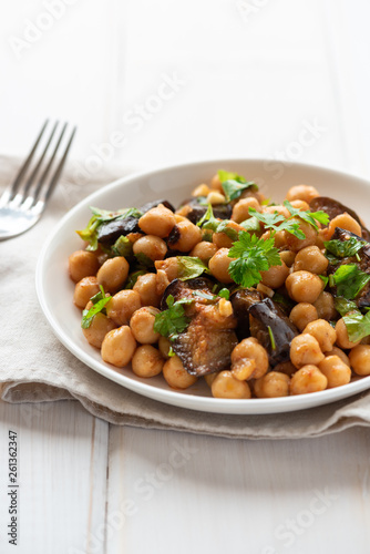 Cooked chickpeas in a plate on a light background. Vegan food.