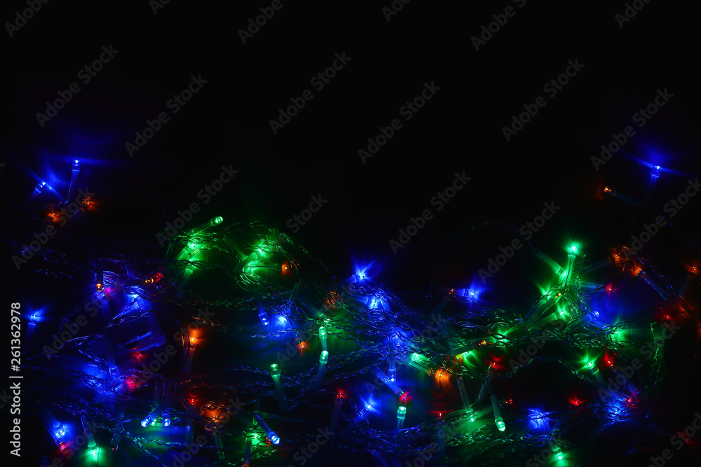 Colored lights (garland) in the dark. Bokeh effect Festive illumination. Colored lights (garland) in the dark. Bokeh effect Festive illumination.