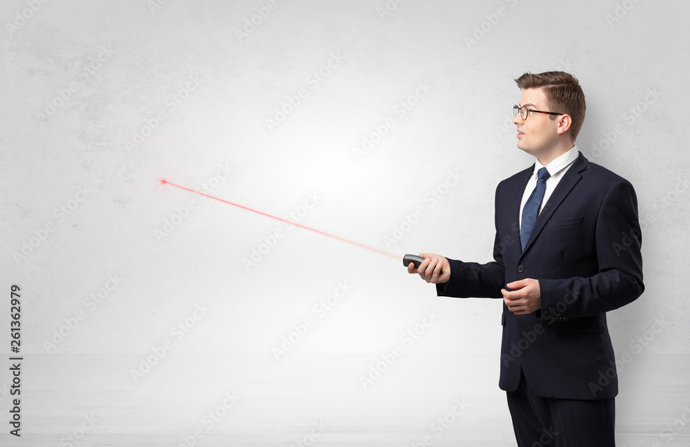 Young businessman with laser pointer and copyspace white wall
Young businessman with laser pointer and copyspace white wall