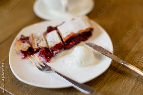 strudel with cherries. Cutlery fork and knife. dessert with tea