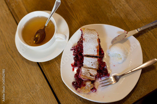 strudel with cherries. Cutlery fork and knife. dessert with tea